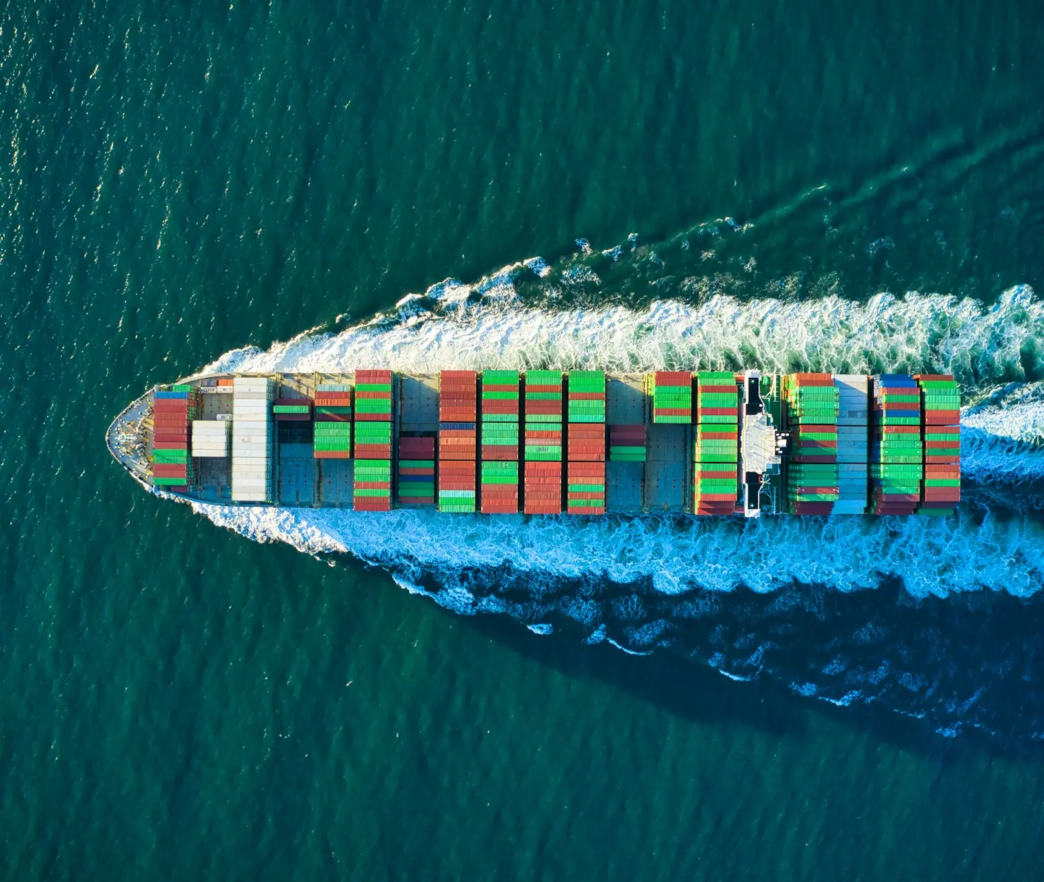 aerial view of blue and white boat on body of water during daytime